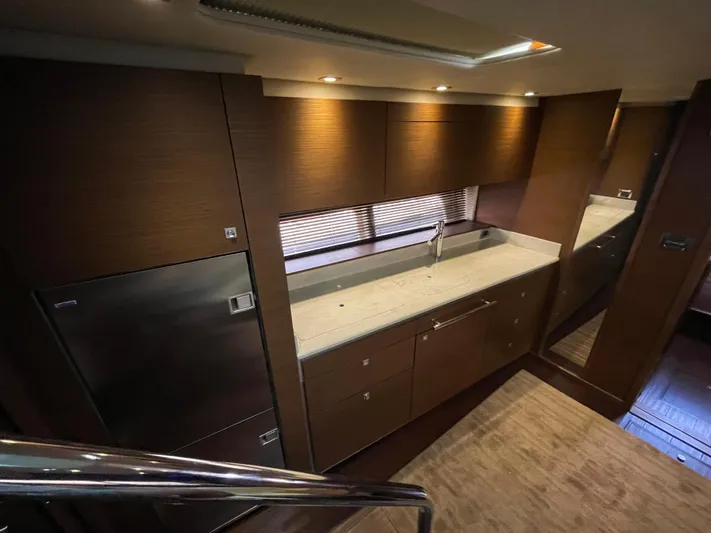 Southern Accent Yacht Photos Pics Luxurious kitchen interior of 2014 Sea Ray 470 Sundancer yacht with modern cabinetry.
