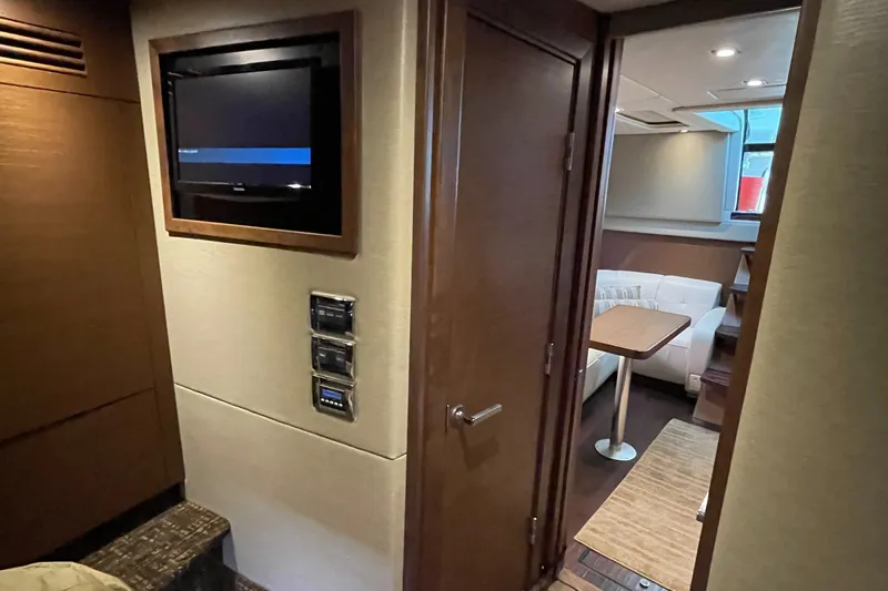 Southern Accent Yacht Photos Pics Interior of 2014 Sea Ray 470 Sundancer yacht with TV and seating area.