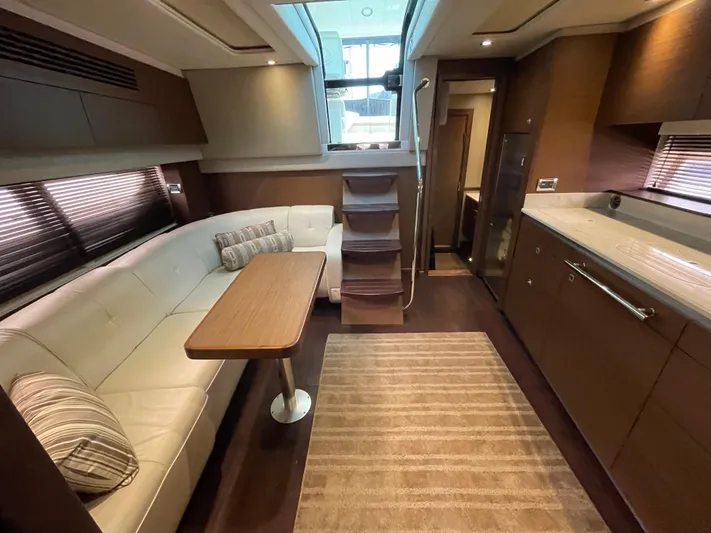 Southern Accent Yacht Photos Pics Luxurious interior of 2014 Sea Ray 470 Sundancer yacht with modern seating and kitchen area.
