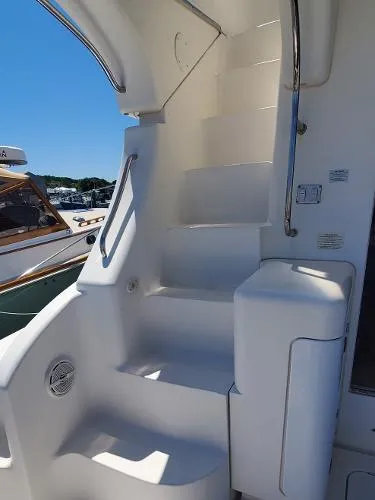 Cash In Advance Yacht Photos Pics Staircase on a 2003 Silverton 38C yacht, featuring sleek white design and stainless steel handrails.