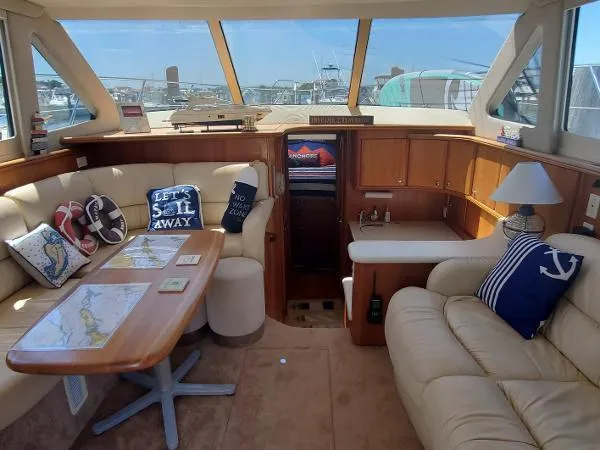 Cash In Advance Yacht Photos Pics Interior of 2003 Silverton 38C yacht with cozy seating and nautical decor.