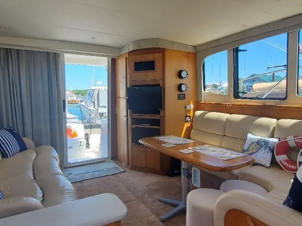 Cash In Advance Yacht Photos Pics Interior of 2003 Silverton 38C yacht with plush seating and nautical decor.