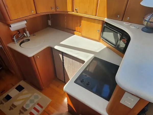 Cash In Advance Yacht Photos Pics 2003 Silverton 38C yacht kitchen with sink, stove, and microwave.