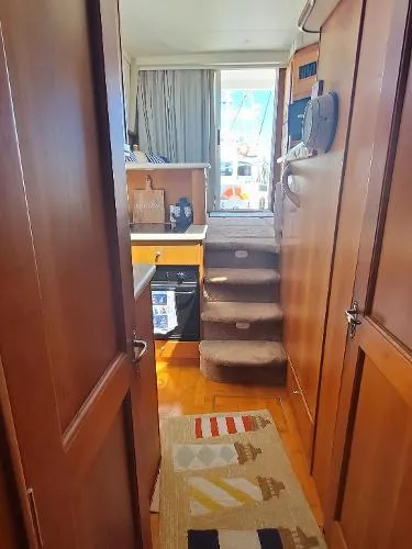 Cash In Advance Yacht Photos Pics 2003 Silverton 38C yacht interior with wooden cabinetry and carpeted stairs.