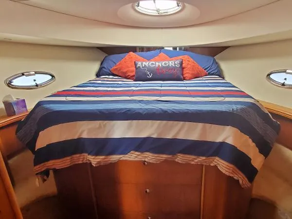 Cash In Advance Yacht Photos Pics 2003 Silverton 38C yacht bedroom with striped bedding and nautical-themed pillows.