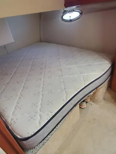 Cash In Advance Yacht Photos Pics 2003 Silverton 38C boat cabin with a comfortable mattress and porthole window.