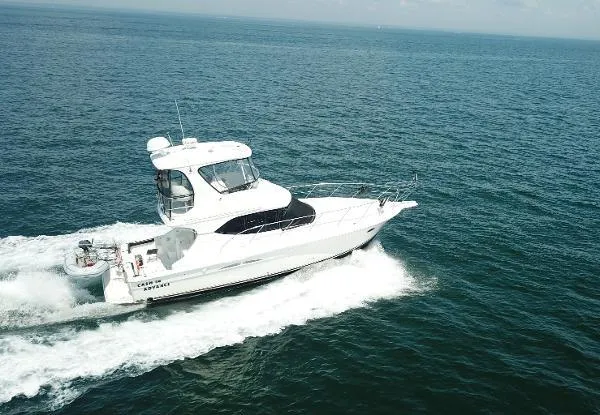 Cash In Advance Yacht Photos Pics 2003 Silverton 38C yacht cruising on open sea under clear skies.