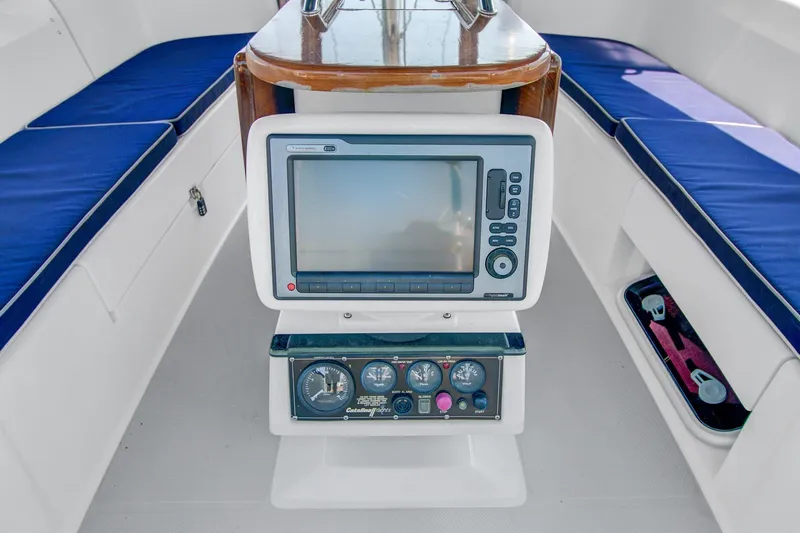  Yacht Photos Pics Cockpit of 2011 Catalina 445 sailboat with navigation equipment and blue cushioned seating.