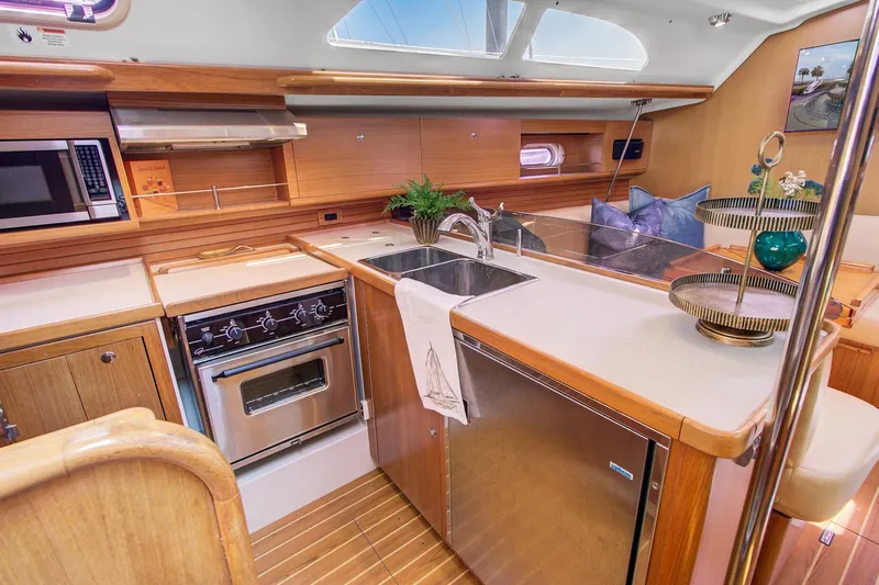  Yacht Photos Pics Luxurious Catalina 445 yacht kitchen interior with modern appliances, wooden cabinetry, and elegant decor, 2011 model.