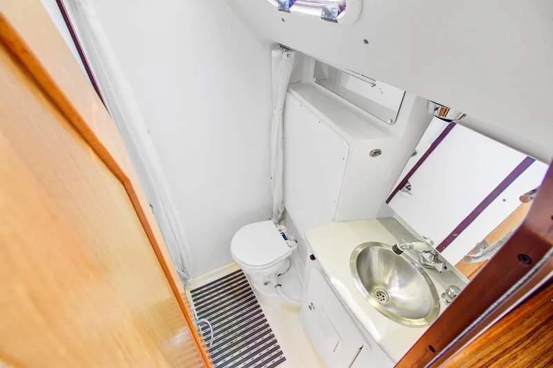  Yacht Photos Pics Compact bathroom in 2011 Catalina 445 yacht with sink, toilet, and mirror.