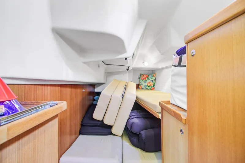  Yacht Photos Pics Interior cabin of 2011 Catalina 445 sailboat with cushions and wooden cabinetry.