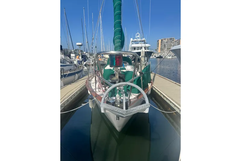Juniper Yacht Photos Pics 1988 Pacific Seacraft 34 sailboat docked in a marina under clear blue skies.