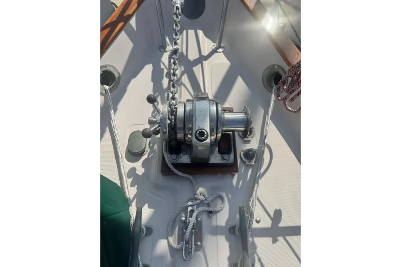 Juniper Yacht Photos Pics Anchor windlass on 1988 Pacific Seacraft 34 sailboat deck, with ropes and chains.