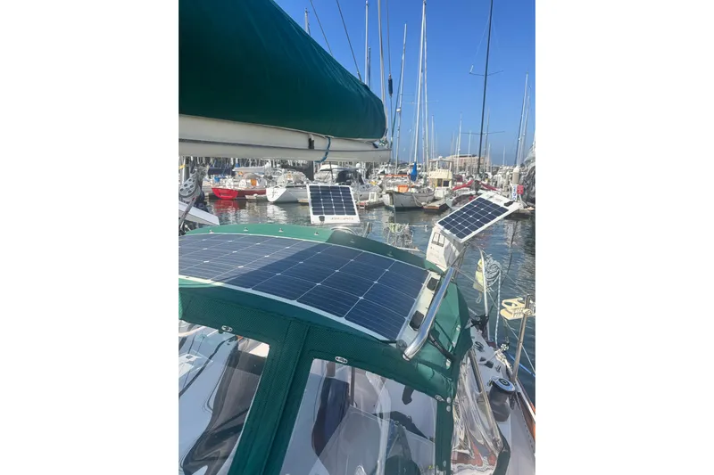 Juniper Yacht Photos Pics 1988 Pacific Seacraft 34 sailboat with solar panels in a marina setting.