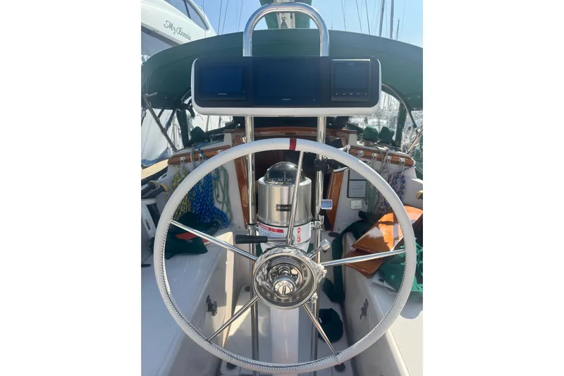 Juniper Yacht Photos Pics Steering wheel of a 1988 Pacific Seacraft 34 sailboat with navigation equipment.