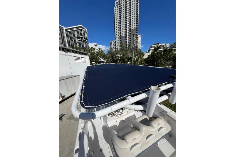  Yacht Photos Pics 2008 Donzi 38 ZFX Open boat with blue cover, urban skyline background.