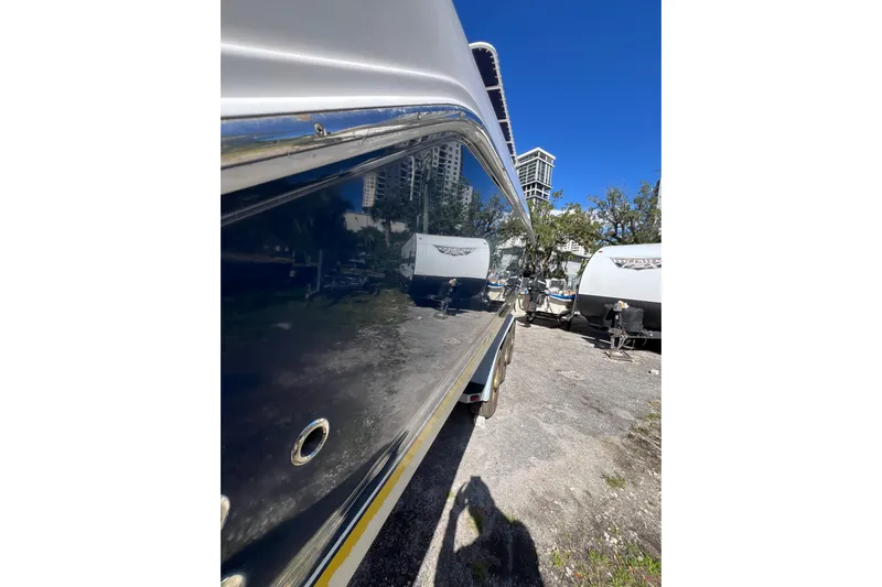  Yacht Photos Pics 2008 Donzi 38 ZFX Open boat side view with shiny hull and urban background.