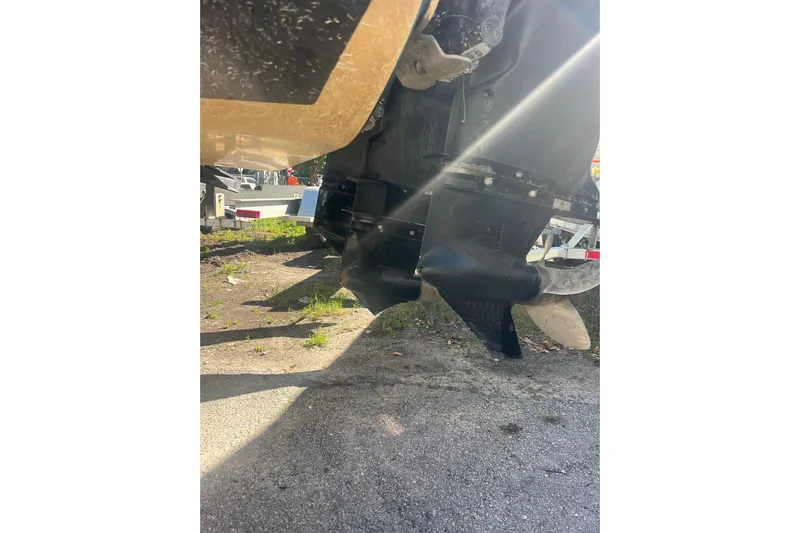  Yacht Photos Pics 2008 Donzi 38 ZFX Open boat propellers in sunlight, parked on pavement.