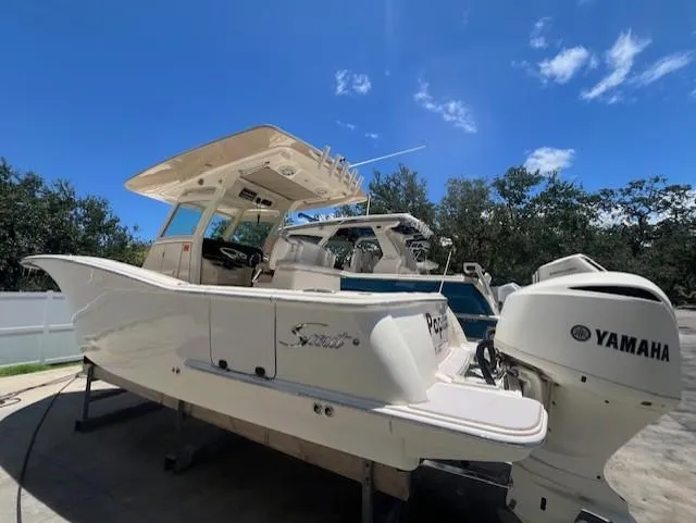  Yacht Photos Pics 2018 Scout 300LXF boat with Yamaha engines under a clear blue sky.