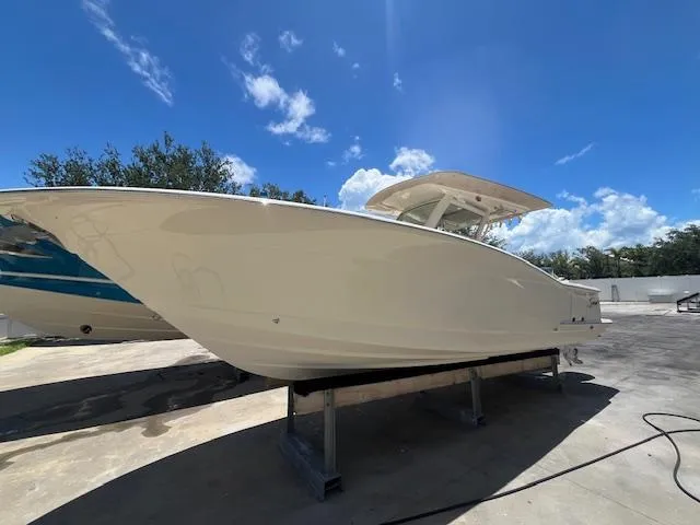  Yacht Photos Pics 2018 Scout 300LXF boat on display under a clear blue sky.