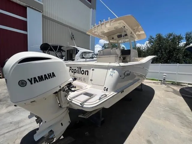  Yacht Photos Pics 2018 Scout 300LXF boat with Yamaha engine, docked outdoors under clear sky.