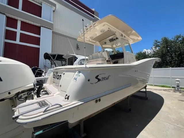  Yacht Photos Pics 2018 Scout 300LXF boat in storage, featuring sleek design and modern amenities.