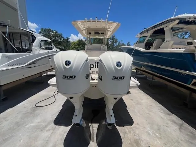  Yacht Photos Pics 2018 Scout 300LXF boat with dual Yamaha 300 engines, docked alongside other boats.
