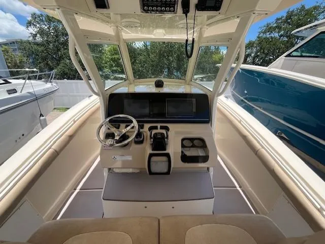  Yacht Photos Pics 2018 Scout 300LXF boat interior with steering wheel and control panel.