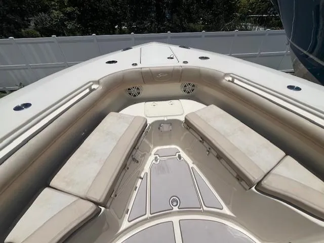  Yacht Photos Pics 2018 Scout 300LXF boat interior with cushioned seating and speakers.