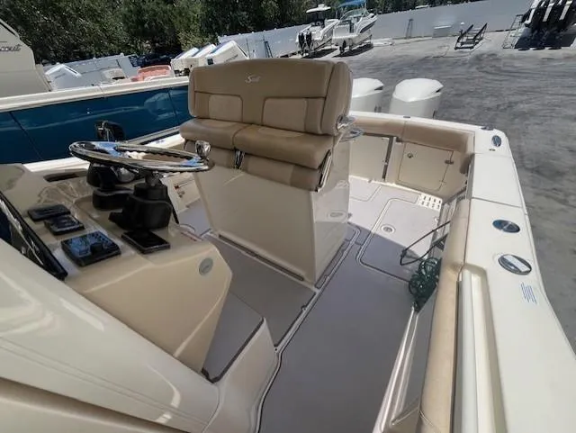  Yacht Photos Pics 2018 Scout 300LXF boat interior with helm, seating, and controls.