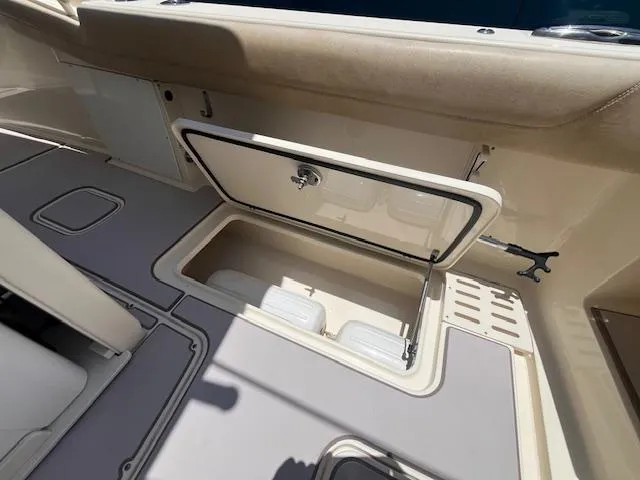  Yacht Photos Pics 2018 Scout 300LXF boat storage compartment with open hatch, showcasing interior space.