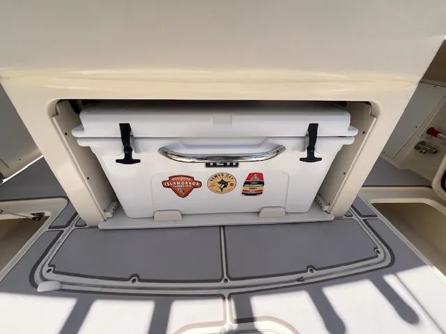  Yacht Photos Pics 2018 Scout 300LXF boat cooler storage with stickers, featuring a secure latch system.