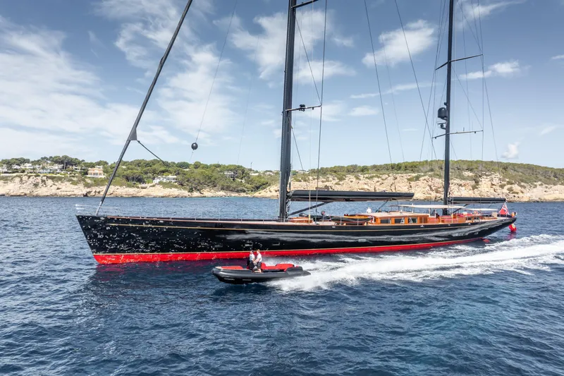 Maximus Yacht Photos Pics 2023 Vitters Cruising Ketch sailing near rocky coastline under clear skies.