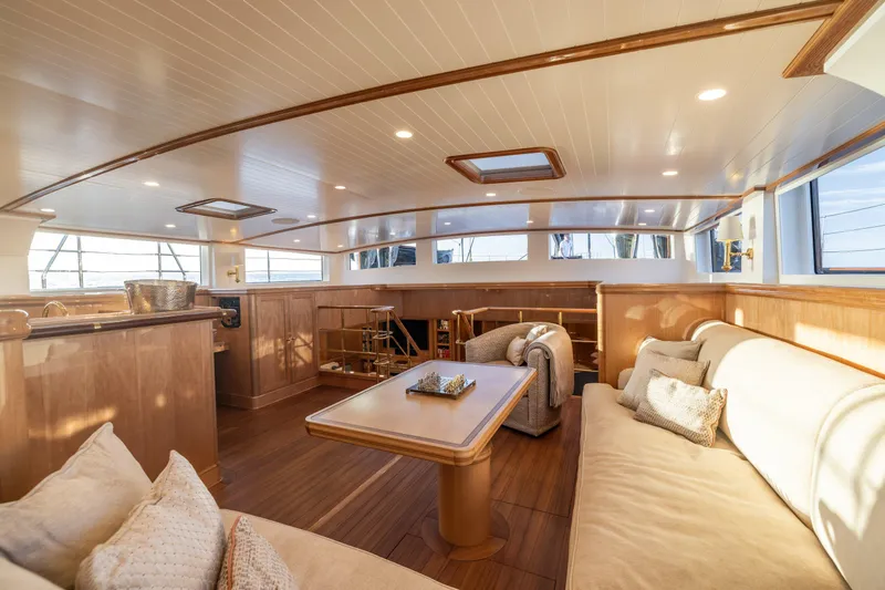 Maximus Yacht Photos Pics Luxurious interior of 2023 Vitters Cruising Ketch with elegant wood finishes and plush seating.