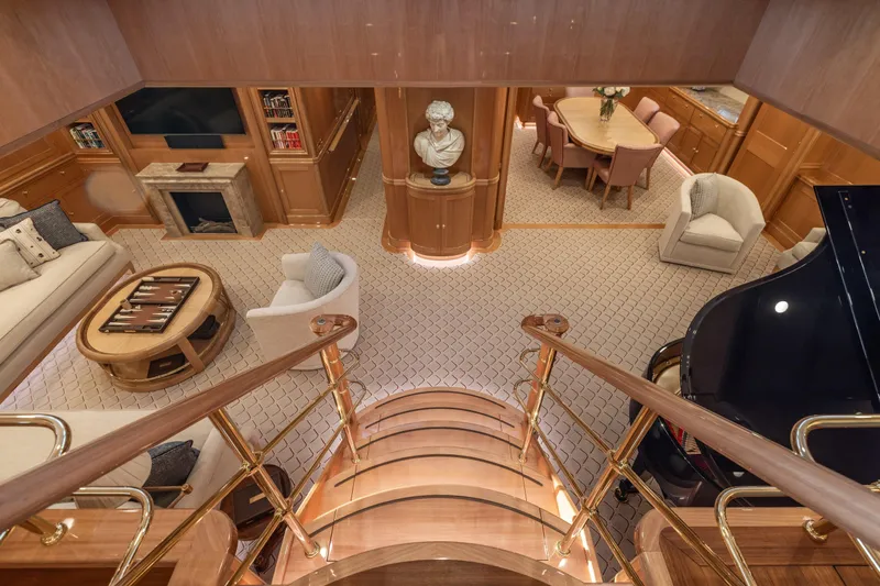 Maximus Yacht Photos Pics Luxurious interior of 2023 Vitters Cruising Ketch with elegant staircase, grand piano, and plush seating.