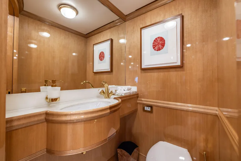 Maximus Yacht Photos Pics Luxurious bathroom in 2023 Vitters Cruising Ketch with elegant wood paneling and modern fixtures.