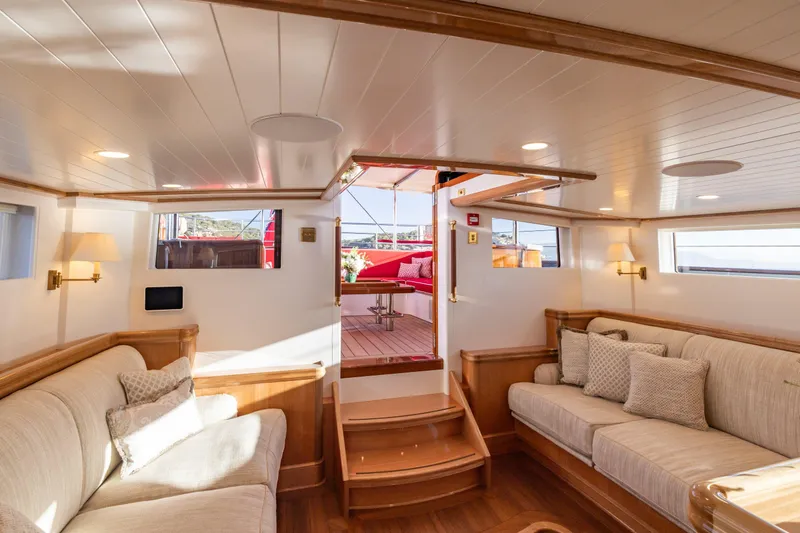 Maximus Yacht Photos Pics Luxurious interior of 2023 Vitters Cruising Ketch with elegant seating and wooden accents.