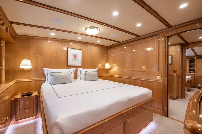 Maximus Yacht Photos Pics Luxurious cabin interior of 2023 Vitters Cruising Ketch with elegant wood paneling and cozy lighting.