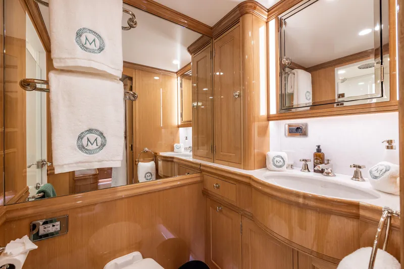 Maximus Yacht Photos Pics Luxurious bathroom in 2023 Vitters Cruising Ketch, featuring elegant wood cabinetry and plush towels.