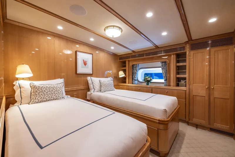 Maximus Yacht Photos Pics Luxurious twin cabin on 2023 Vitters Cruising Ketch yacht, featuring elegant wood finishes and cozy bedding.