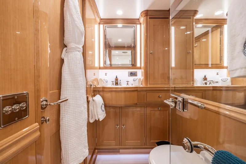 Maximus Yacht Photos Pics Luxurious bathroom in 2023 Vitters Cruising Ketch, featuring elegant wood cabinetry and modern fixtures.