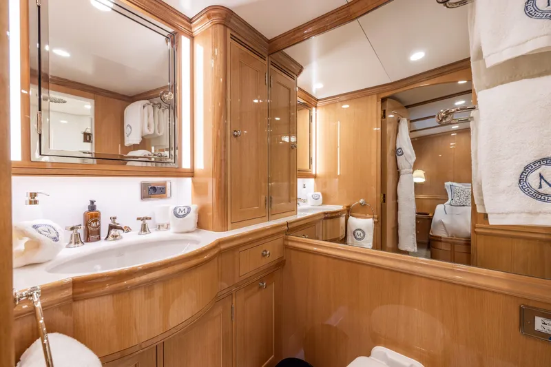 Maximus Yacht Photos Pics Luxurious bathroom in 2023 Vitters Cruising Ketch with elegant wood cabinetry and modern fixtures.