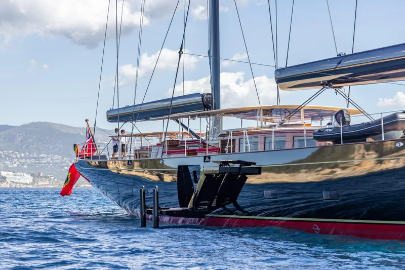 Maximus Yacht Photos Pics 2023 Vitters Cruising Ketch sailing on blue waters with scenic mountain backdrop.