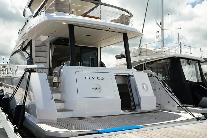 Yacht Photos Pics 2024 Azimut Fly 68 yacht docked, showcasing sleek design and luxury features.