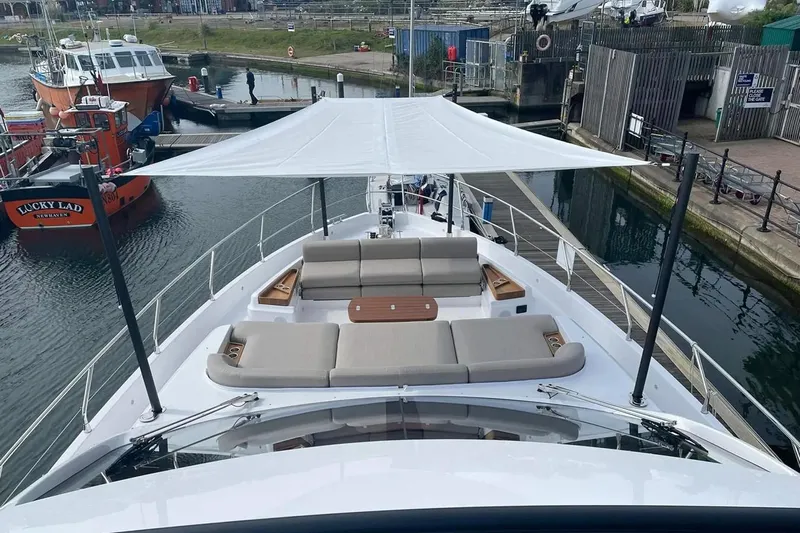  Yacht Photos Pics 2024 Azimut Fly 68 yacht with spacious deck and sunshade in marina setting.