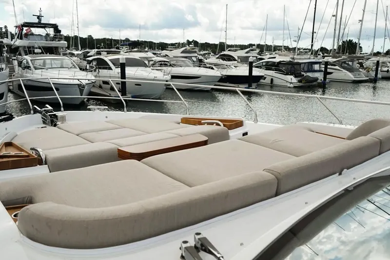 Yacht Photos Pics Luxurious 2024 Azimut Fly 68 yacht with spacious sunbathing area, docked in a marina.