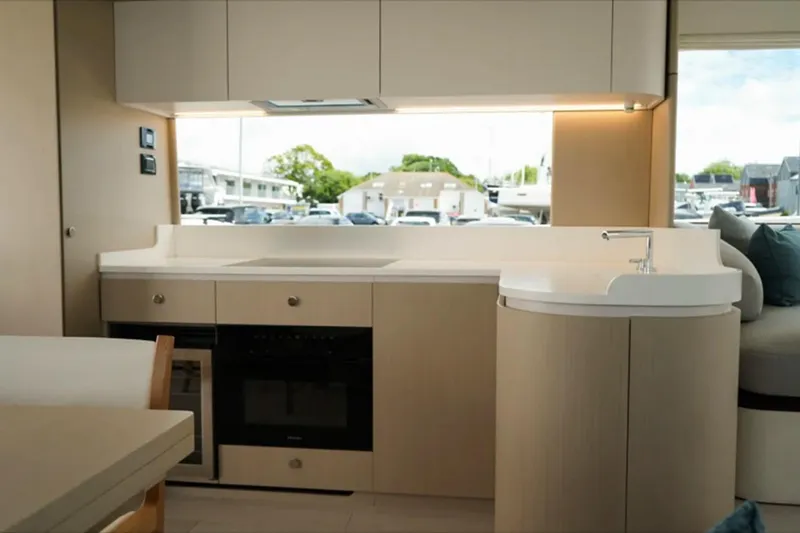  Yacht Photos Pics Modern kitchen interior of 2024 Azimut Fly 68 yacht, featuring sleek cabinetry and appliances.