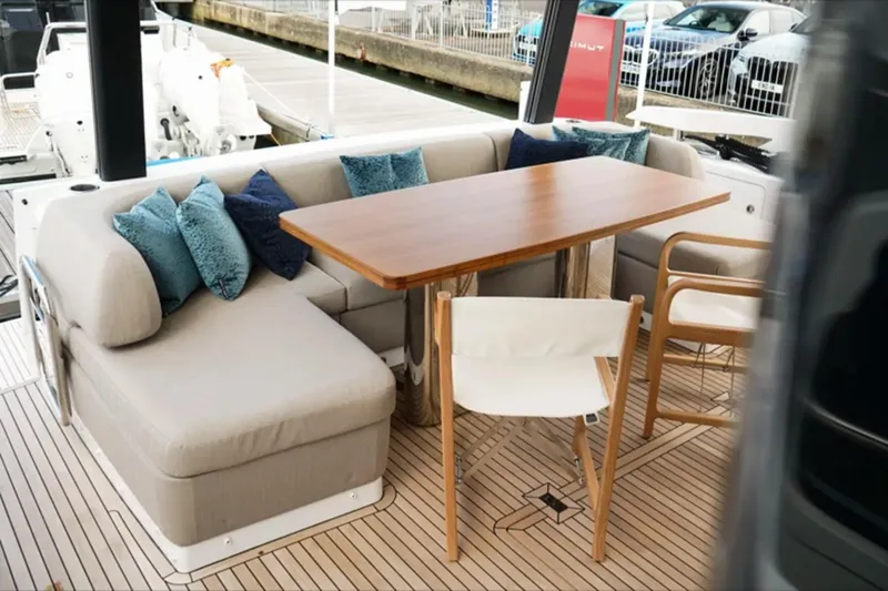  Yacht Photos Pics Luxurious seating area on 2024 Azimut Fly 68 yacht with elegant wooden table.