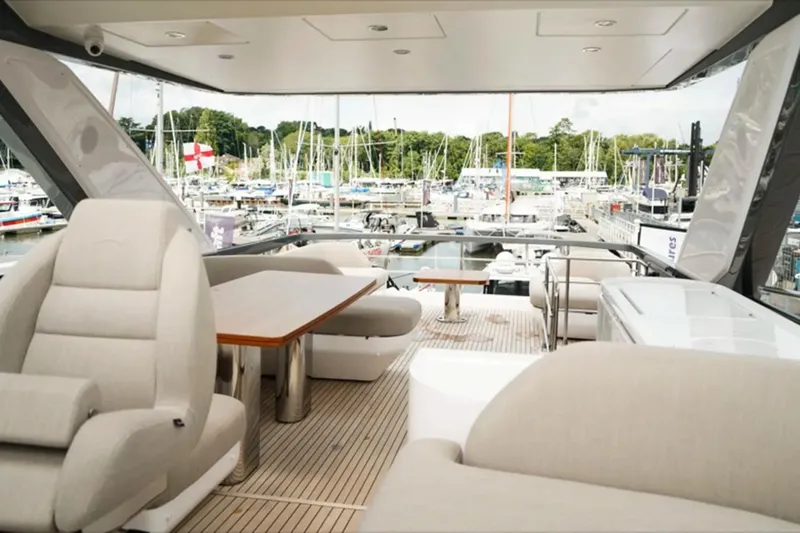  Yacht Photos Pics Luxurious 2024 Azimut Fly 68 yacht interior with elegant seating and marina view.