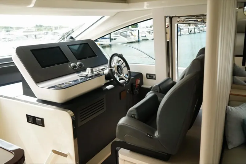  Yacht Photos Pics Luxurious helm of 2024 Azimut Fly 68 yacht with modern controls and dual screens.